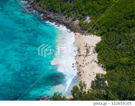 An unspoilt sandy beach in the middle of a rainforest. Seychelles, Mahe. Anse Capucins beach. An unspoilt sandy beach in the middle of a rainforest. Seychelles, Mahe. Anse Capucins beach. 122659105