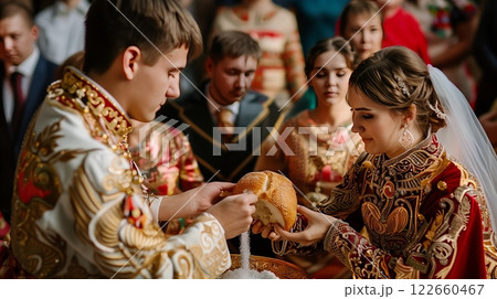A traditional Russian wedding features a ceremonial bread and salt sharing, with guests in traditional attire. 122660467