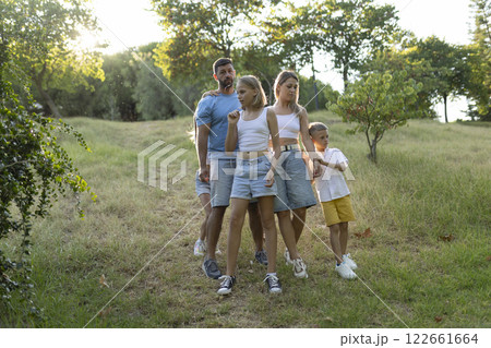 Family taking a walk together in nature on a summer day 122661664