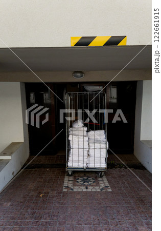 cart with metal baskets full of clean towels cart with metal baskets full of clean towels 122661915