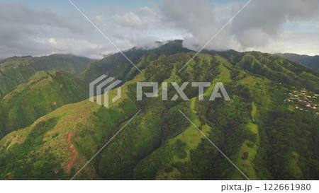 Aerial drone capture vibrant green hills landscape of Tahiti mountainous terrain, mountain peaks hide in clouds. Tropical island untouched beauty and dramatic topography. Remote nature travel Aerial drone capture vibrant green hills landscape of Tahiti mountainous terrain, mountain peaks hide in clouds. Tropical island untouched beauty and dramatic topography. Remote nature travel 122661980