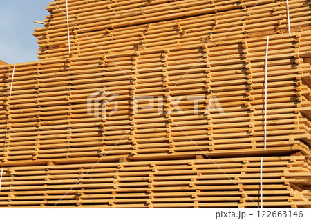 Stack of fresh pine boards in a sawmill warehouse. Stacks of lumber 122663146