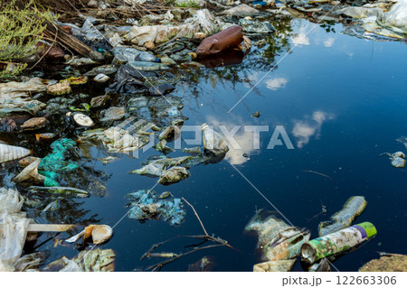 River covered with garbage. Garbage and pollution on water. Environment pollution 122663306