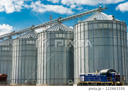 Metal tanks for storage of grain. Modern granary elevator. Loading and transportation of agricultural products by railway. 122663330
