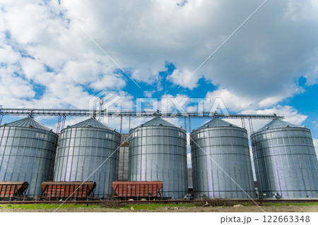 Metal tanks for storage of grain. Five large metal agricultural silos for grain storage and drying. Agricultural warehouse. Agro industry 122663348