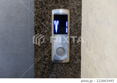 The control panel displays illuminated buttons for selecting floors in a contemporary apartment elevator setup 122663445