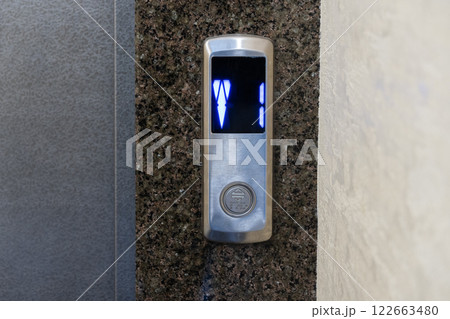 A sleek elevator panel with illuminated floor buttons fits perfectly with the apartment's modern design 122663480