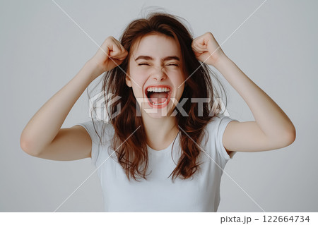 A waist-up studio portrait of a girl laughing uncontrollably, her head slightly tilted back A waist-up studio portrait of a girl laughing uncontrollably, her head slightly tilted back 122664734