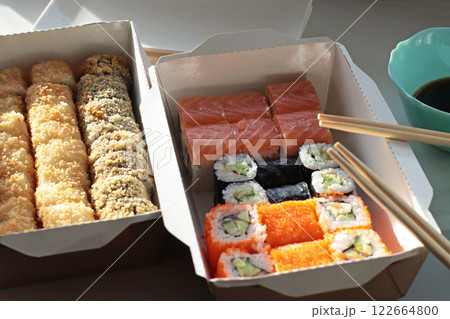 fish bun and sushi set breaded rice japanese cuisine japanese food delivery bright buns hand chopsticks with roll california philadelphia white dishes soy saucehands holding chopsticks fish bun and sushi set breaded rice japanese cuisine japanese food delivery bright buns hand chopsticks with roll california philadelphia white dishes soy saucehands holding chopsticks 122664800
