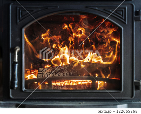 Fire with wood in the stove close up Fire with wood in the stove close up 122665268