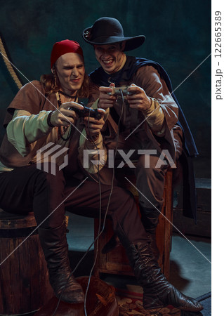 With intense focus, two pirates battle in video game, gripping controllers against dark vintage background. 122665389