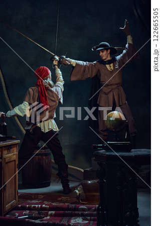 Duel of steel. Two pirates cross swords in dramatic clash against dark vintage background. Duel of steel. Two pirates cross swords in dramatic clash against dark vintage background. 122665505