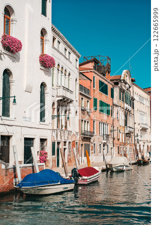 A row of colorful buildings with a blue boat in the middle. A row of colorful buildings with a blue boat in the middle. 122665999