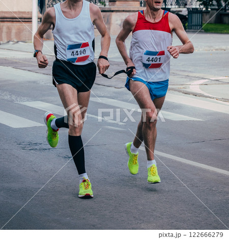 blind athlete is paired with his guide running marathon in city 122666279