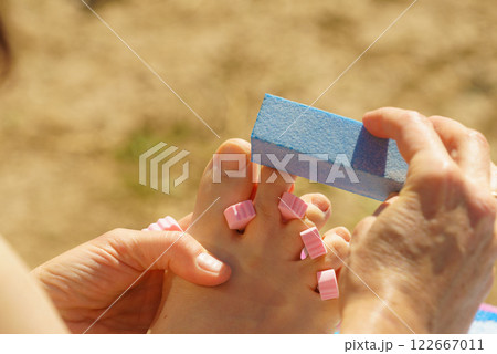 Woman pedicure outdoor Woman pedicure outdoor 122667011