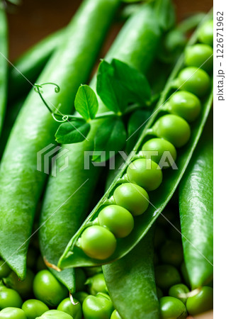 Macro shot of green sugar snap peas with leaf. 122671962