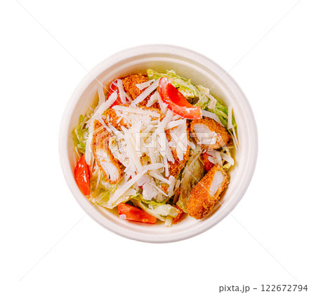 Fresh salad with crispy chicken, lettuce, tomatoes, and cheese prepared in a takeout bowl for a quick meal option Fresh salad with crispy chicken, lettuce, tomatoes, and cheese prepared in a takeout bowl for a quick meal option 122672794