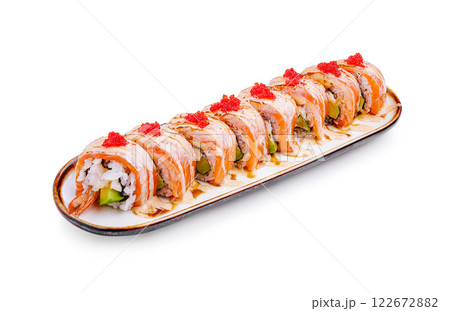 Sushi platter featuring colorful rolls garnished with vibrant toppings served on a sleek plate 122672882