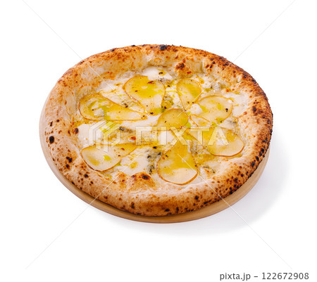 Delicious pizza topped with thinly sliced pear and creamy cheese served on a wooden platter at a cozy restaurant 122672908