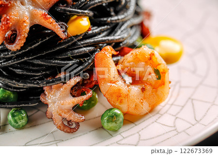 Portion of gourmet black pasta with seafood 122673369