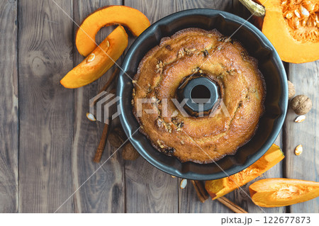 baking background. Bakery. Autumn baking table scene with pumpkin pie ingredients on a dark wood background. 122677873