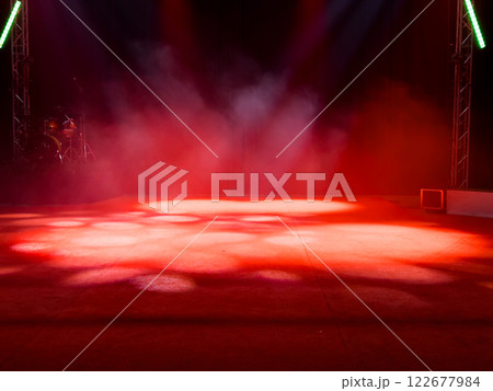Empty stage with red lights and smoke effects in theater setting Empty stage with red lights and smoke effects in theater setting 122677984