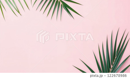 Tropical palm leaves creating frame on pastel pink background Tropical palm leaves creating frame on pastel pink background 122678986