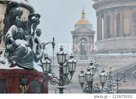 a snow-covered New Year's city decorated for the celebration of the new year, the golden dome of St. Isaac's Cathedral, walking tourists 122679102