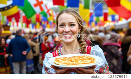Young woman holding a plate of pancakes during a traditional celebration 122679913