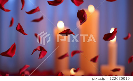 Rose petals falling down against the background of burning candles 122680019