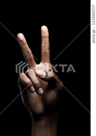 Hand with two fingers raised. Victory, peace sign. Black background. Ai Generative 122680257
