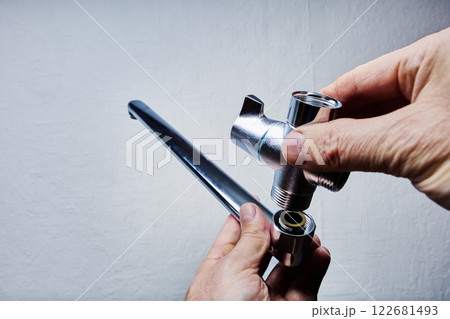 Installation of bathtub faucet with hand shower with mixer tap and long spout for wall mounted. Installation of bathtub faucet with hand shower with mixer tap and long spout for wall mounted. 122681493