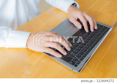 ノートパソコンで作業をする男性の手元 122684272