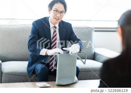 大口顧客の自宅訪問をする外商の男性ビジネスマン 大口顧客の自宅訪問をする外商の男性ビジネスマン 122686129