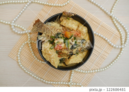 Fried fish with curry in a bowl Fried fish with curry in a bowl 122686481