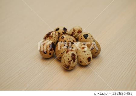 Quail eggs on a wooden table Quail eggs on a wooden table 122686483