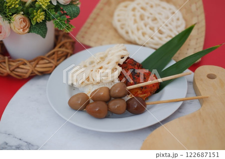 rice with skewered quail eggs and crackers on marble table. Selective focus. rice with skewered quail eggs and crackers on marble table. Selective focus. 122687151