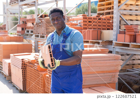 African american worker warehouse lays bricks 122687521