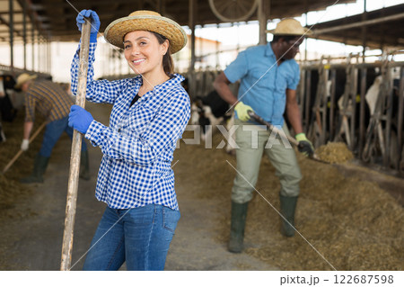 Latino american female farmer standing at the cow farm 122687598