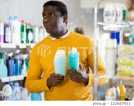 During shopping, African male client choose shampoo, shower gel During shopping, African male client choose shampoo, shower gel 122687651