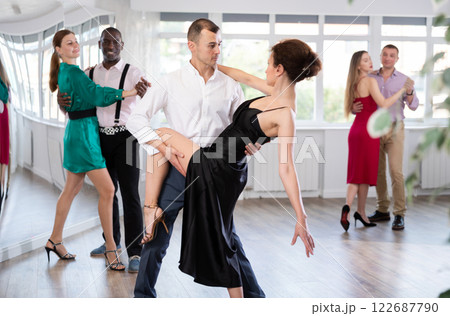 Woman dances incendiary tango with man partner during choreography lesson Woman dances incendiary tango with man partner during choreography lesson 122687790