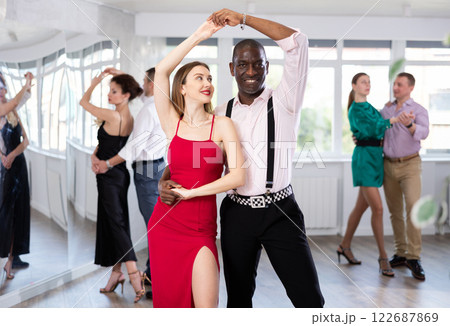 Classical dances performed by women and men in festive clothes Classical dances performed by women and men in festive clothes 122687869
