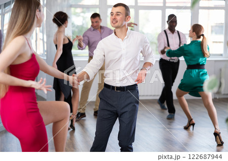 Man and woman practicing swing dance in dancing studio Man and woman practicing swing dance in dancing studio 122687944