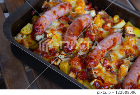 Baked vegetables with sausages Baked vegetables with sausages 122688086