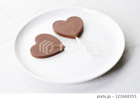 Chocolate hearts on white wooden background, valentines day. Chocolate hearts on white wooden background, valentines day. 122688355