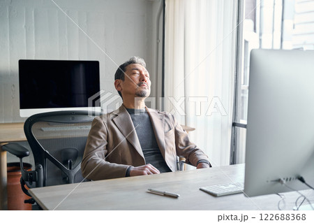 仕事中、眠気に襲われる男性 122688368