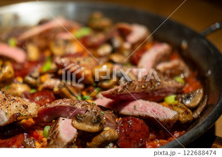 Paella with pork. It is one of the best-known dishes in Spanish cuisine. Paella with pork. It is one of the best-known dishes in Spanish cuisine. 122688474