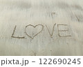 Writing letter love on sand. 122690245