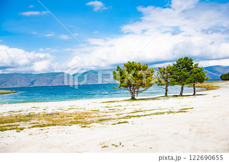 Sandy beach. Seaside vacation, golden beaches. Blue waters of the sea. Lake, ocean, sea 122690655