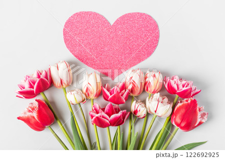 Spring composition on gray background of flowers pink and white tulips with pink heart shape made of paper for text. Happy Mother's Day greeting card, happy Valentine's Day, March 8, happy birthday 122692925
